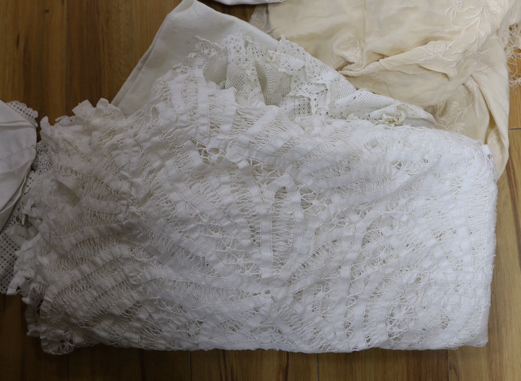 A late 19th century Chinese cream silk embroidered shawl, a tape lace bed cover and a collection of smaller cloths with crochet edges